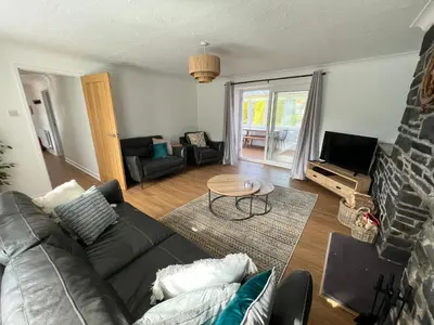 a living room with a couch and a table at Escapism Wales Garthowen in Llanrhystyd
