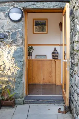 a door into a house with a stone wall at 2 Bed in Dolgellau oc-bow284 in Trawsfynydd