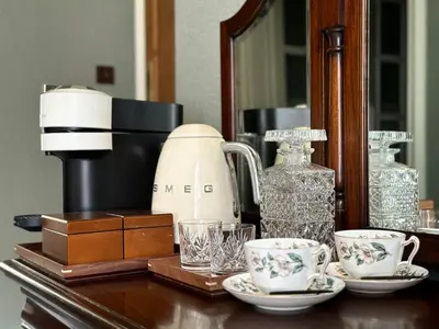 a table topped with cups and glasses and a coffee maker at The Buckley Arms in Dinas Mawddwy