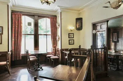 a dining room with tables and chairs and a window at The Buckley Arms in Dinas Mawddwy