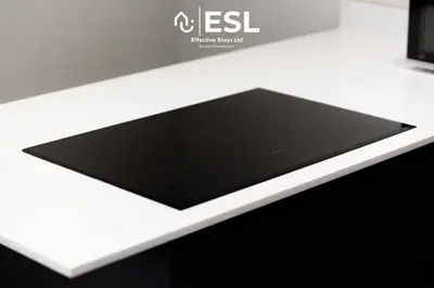 a black tablet sitting on top of a white counter at Comfy Modern 2 Bedroom Duplex Apartment with Sun Terrace in Shrewsbury