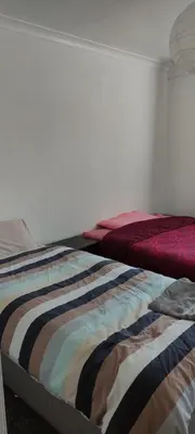 a bedroom with a bed with a blanket on it at Toad Hall Hostel in Machynlleth