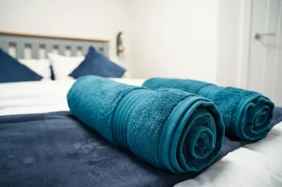 a group of blue blankets on a bed at The Garden House in Shrewsbury