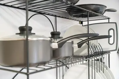 a bunch of pots and pans on a rack in a kitchen at The Garden House in Shrewsbury