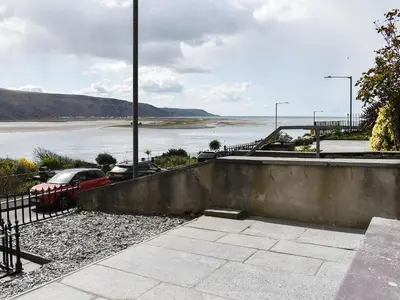 a view of a body of water with cars parked at Ty Isaf in Barmouth