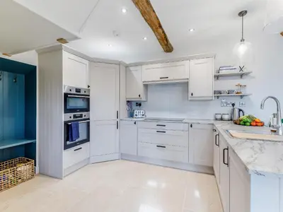 a white kitchen with white cabinets and appliances at Little Whitley - Uk38099 in Great Hanwood