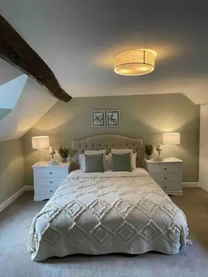 a bedroom with a large bed with two night stands at Penddol Cottage Llangollen in Llangollen