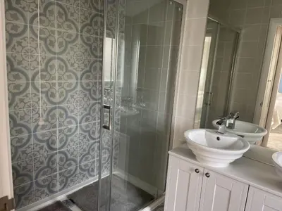 a bathroom with a shower and a sink and a sink at Sea Breeze Lodge in Aberaeron