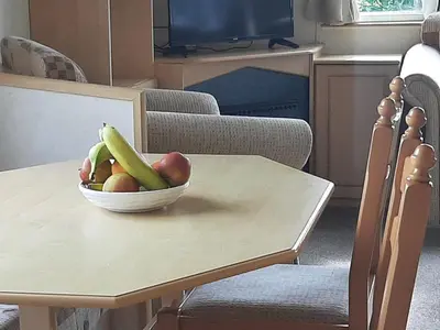 a bowl of fruit sitting on a table at Cadwgan Caravan in Dyffryn