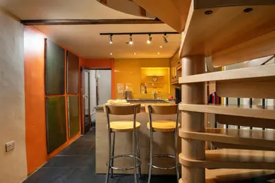 a kitchen with a bar with stools in it at Finest Retreats - Dolwar Cottage in Ffestiniog