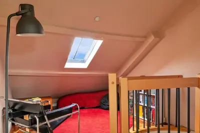 a small attic bedroom with a bed and a window at Finest Retreats - Dolwar Cottage in Ffestiniog