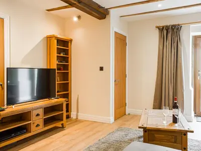 a living room with a large flat screen tv at Wheelwright Cottage in Clunbury