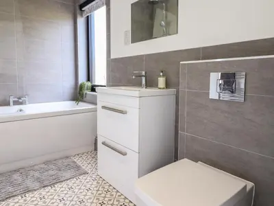 a bathroom with a sink and a toilet and a tub at The Sheep Shed in Oswestry