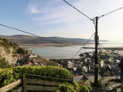 a view of a town and a body of water at 2 Bwth Mawr in Barmouth