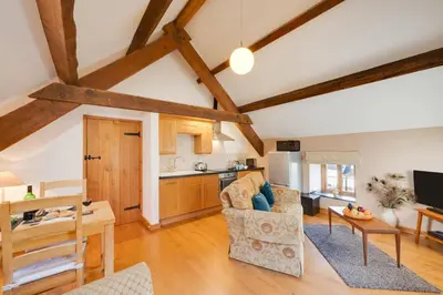 a kitchen and living room with wooden beams at 1 Bed in Dolgellau oc-bow283 in Trawsfynydd