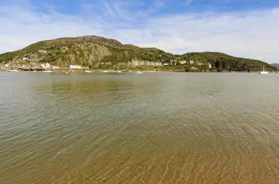 a large body of water with a mountain in the background at 1 Bed in Dolgellau oc-bow283 in Trawsfynydd