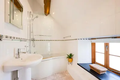 a white bathroom with a sink and a shower at 1 Bed in Dolgellau oc-bow283 in Trawsfynydd