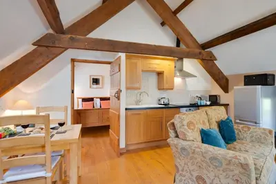 a kitchen and living room with a couch and a table at 1 Bed in Dolgellau oc-bow283 in Trawsfynydd