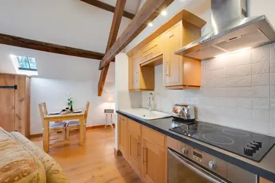 a kitchen with a stove top oven next to a table at 1 Bed in Dolgellau oc-bow283 in Trawsfynydd