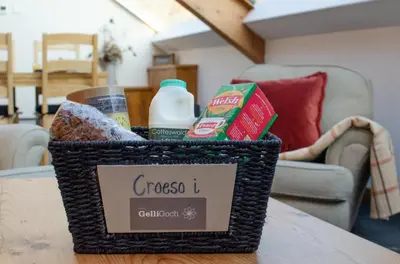 a basket of groceries sitting on a table at 2 Bed in Dolgellau oc-bow282 in Trawsfynydd