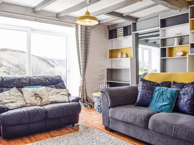a living room with a couch and a chair at Blaen Y Cwm in Carno