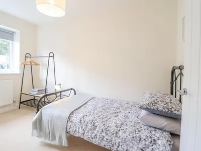 a bedroom with a bed and a lamp at Mawnog Fach in Bala