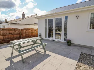 a picnic table on a patio in front of a house at Mawnog Fach in Bala