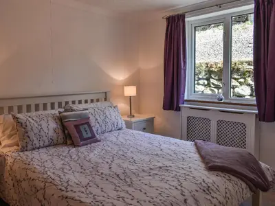 a bedroom with a bed and a window at Morannedd Bach in Dyffryn