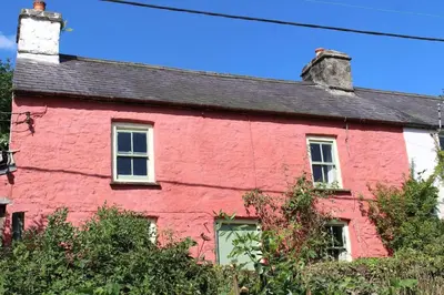 a red house with a black roof at Rhandirmwyn - Cottage - Sleeps 4 - Pet Friendly in Llandovery