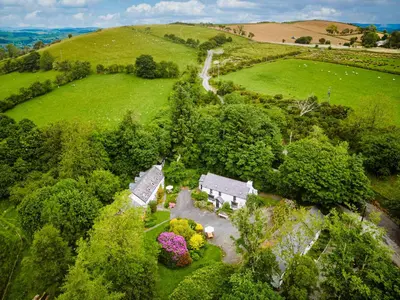 an aerial view of a house in a green field at Brynarth Country Cottages in Aberystwyth