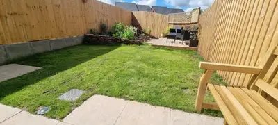 a yard with a wooden fence and a bench at Modern and bright 2-bed home near Ludlow centre - Pass the Keys in Ludlow