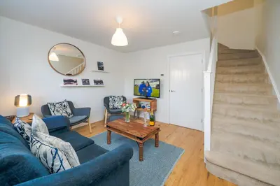 a living room with a blue couch and a table at Modern and bright 2-bed home near Ludlow centre - Pass the Keys in Ludlow