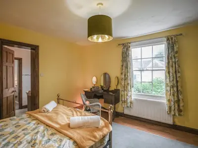 a bedroom with a bed and a window at Home Farm House in Dorrington
