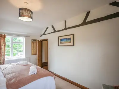 a bedroom with a bed and a window at Home Farm House in Dorrington