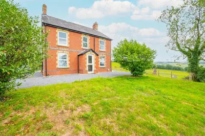 a large brick house with a grassy yard at 5 Bed in Llandovery oc-bow323 in Llangadog