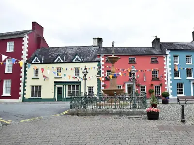 a group of buildings with flags in a street at 5 Bed in Llandovery oc-bow323 in Llangadog
