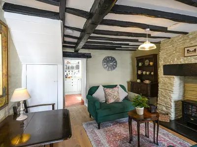 a living room with a green couch and a table at Bwthyn Llys Machynlleth Old Court House in Machynlleth