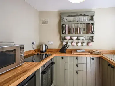 a kitchen with a counter top with a microwave at Bwthyn Llys Machynlleth Old Court House in Machynlleth