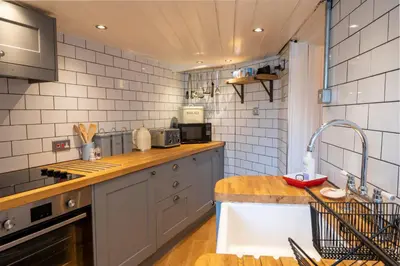 a kitchen with a sink and a counter top at Cottage in heart of Dolgellau with parking in Dolgellau