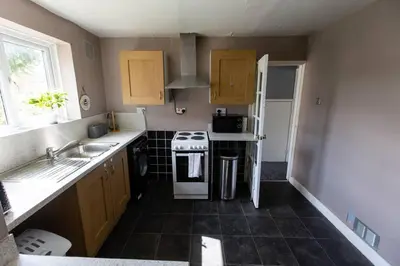 a small kitchen with a stove and a sink at Cul-de-sac Creations in Shrewsbury