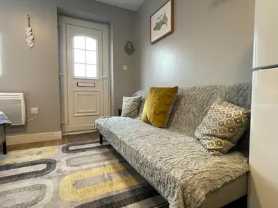 a living room with a couch and a window at Westend Holiday Let 4 Brecon in Brecon