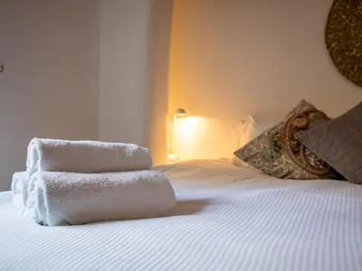 a bedroom with a bed with towels on it at Quaint 1 bedroom cottage in Church Stretton - Pass the Keys in Church Stretton