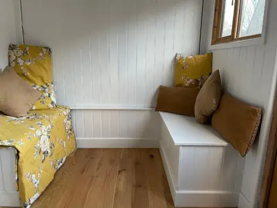 a corner of a room with a couch and a chair at Ty Olwyn Bach, Coity Bach in Brecon