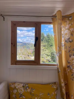 a window in a room with a couch in front at Ty Olwyn Bach, Coity Bach in Brecon