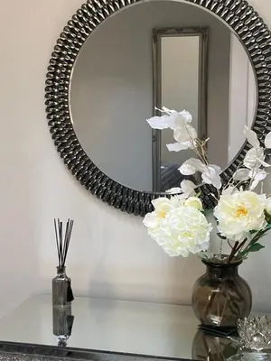 a mirror on a wall next to a table with flowers at Rooftops - bijou sister apartment to Assembly View - free parking permit provided in Ludlow