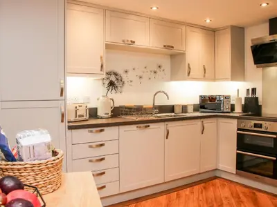 a kitchen with white cabinets and a sink at 6 The Engine Shed in Shrewsbury