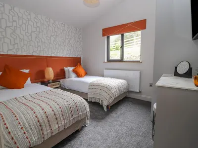 a hotel room with two beds and a window at Pool View in Meifod