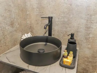 a black sink on a counter in a bathroom at Pool View in Meifod