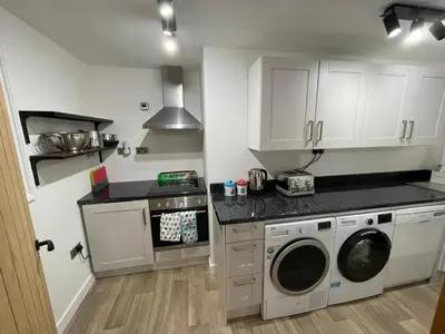 a kitchen with a washer and dryer in it at Converted barn, perfect MTB break, Coed y Brenin in Trawsfynydd