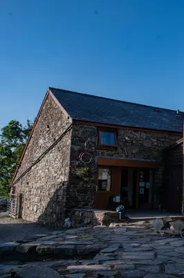 a stone building with a large door on it at Converted barn, perfect MTB break, Coed y Brenin in Trawsfynydd